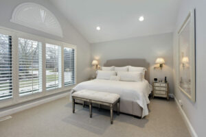 white plantation shutters in a residential bedroom