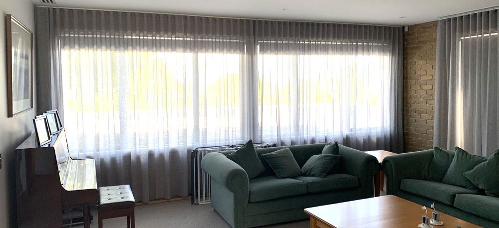 Ceiling to floor sheer curtains with blockout roller blinds behind 1 aspect ratio 1096 500